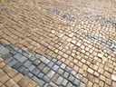 Vertical mosaic wall art with a light gold cream background and pearlescent soft blue wave-like lines