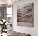 Beige mosaic wall art with vertical tiles in rose, bronze, and gold tones on a soft neutral background