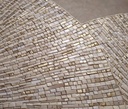 Close up of beige and gold mosaic wall art