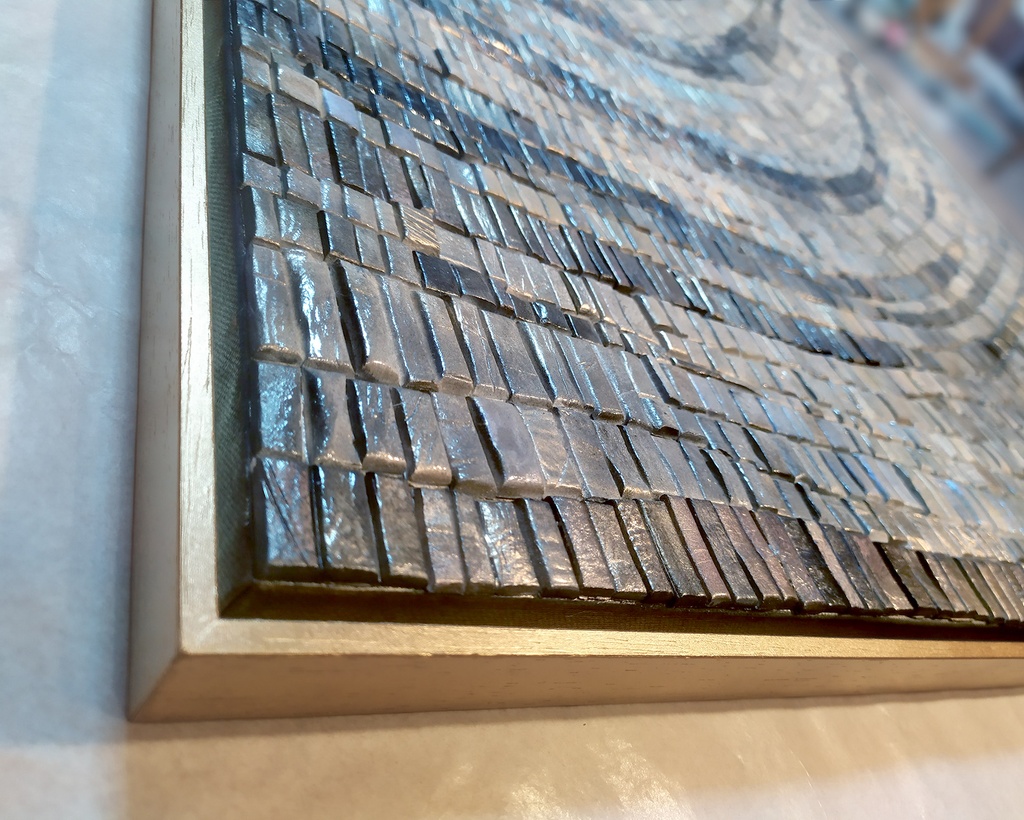 Close up of blue and gray mosaic wall art