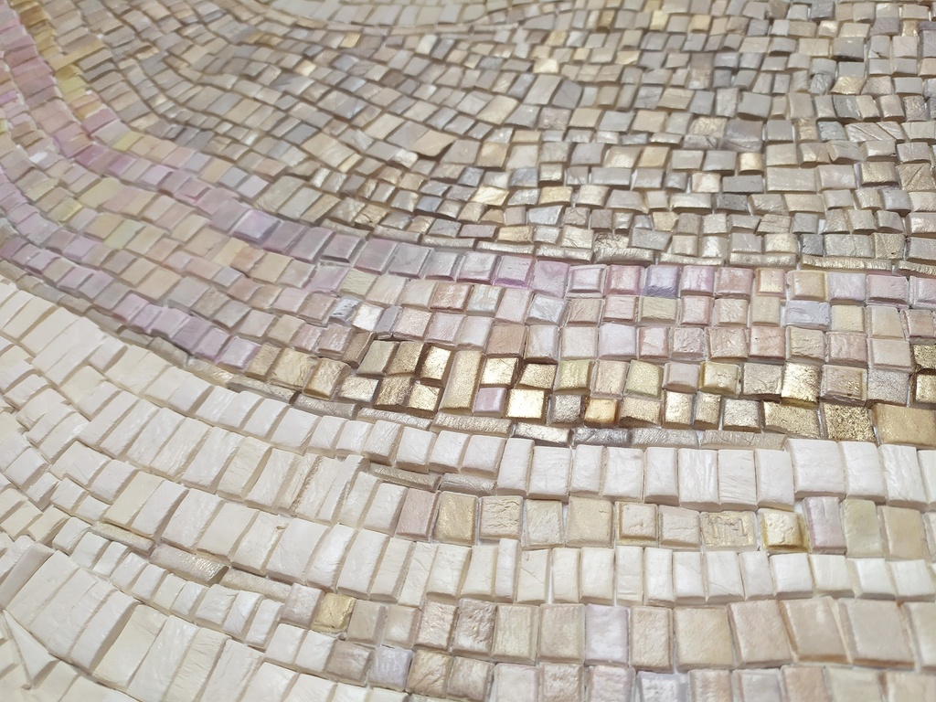 Close up of gold and beige mosaic wall art