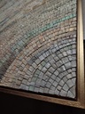 Detail of beige mosaic wall art on canvas with intertwining blue and green accents