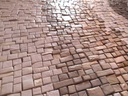 Detail of mosaic wall art in warm rose terracotta bronze shades